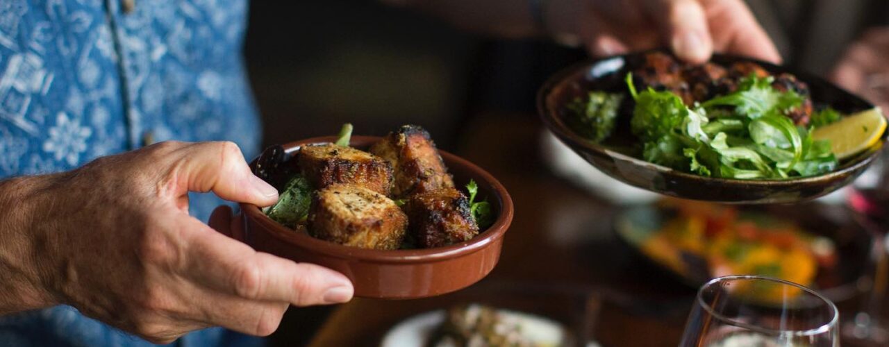 Tapas being passed around a table