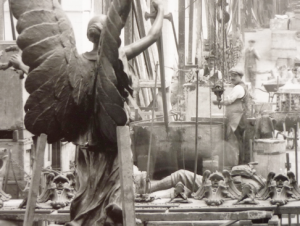 Detail from inside the foundry with Singers workers and the back view of the Shepherds Bush War memorial (still in situ today) by Henry Charles Fehr, a sculptor who had many of his works cast at Singers, including the dragon that graces the top of Cardiff’s City Hall. Printed from the original glass plate negative