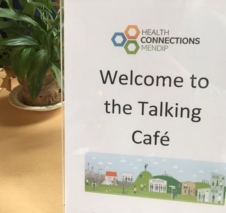 Sign reading "Welcome to the talking café"