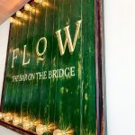 'Flow - the bar on the bridge' sign