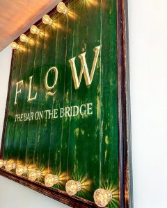 'Flow - the bar on the bridge' sign