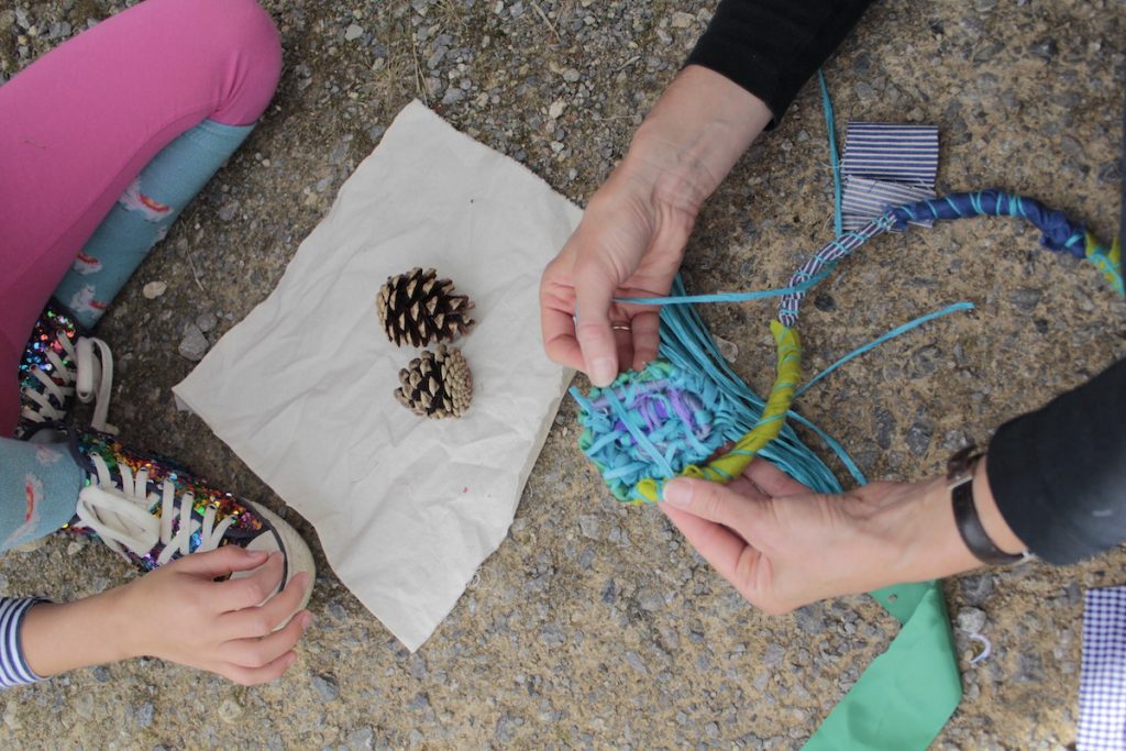 Close up of crafting with string and pine cones
