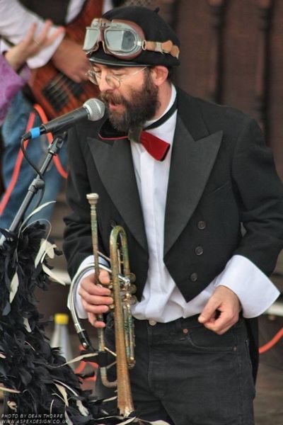 Man singing and holding a trumpet