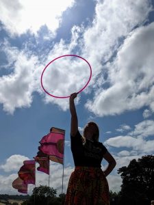 Lady holding up a hula hoop