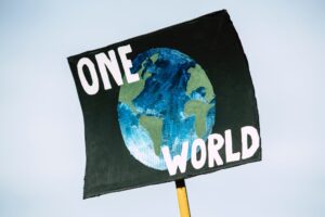 Placard with the words "one world"