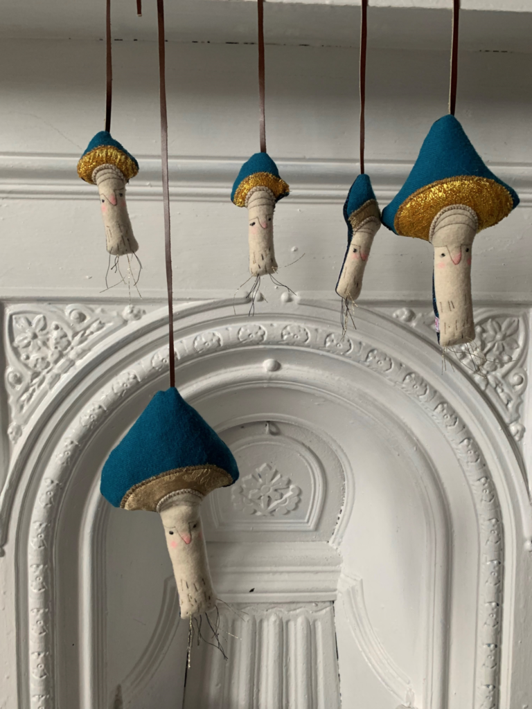 Gaganis Fabric toadstolls hanging from mantlepiece