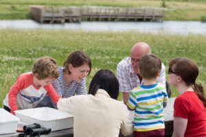 People round a table in a field