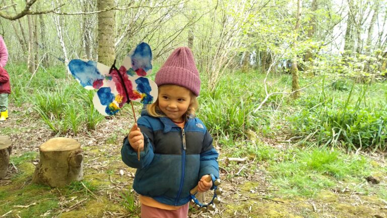 Earthwise - child holding butterfly painting