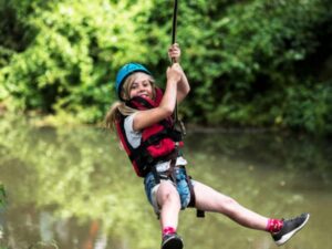 child on zip wire over the river