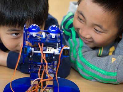Children playing with a robot