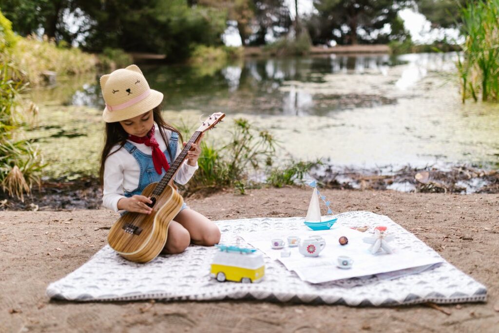 child playing a guitair