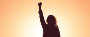 silhouette of person punching the air
