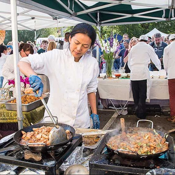 Person cooking at food festival