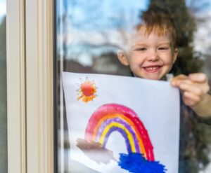 child with rainbow drawing