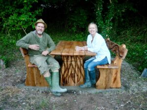 Sculptor, Anthony Rogers and Millennium Green Trustee, Sue Bucklow take a seat at the new picnic table and benches made possible with a grant from Frome Town Council and Frome Community Lottery, 4th September 2013. 