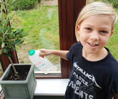 Child with homemade watering can
